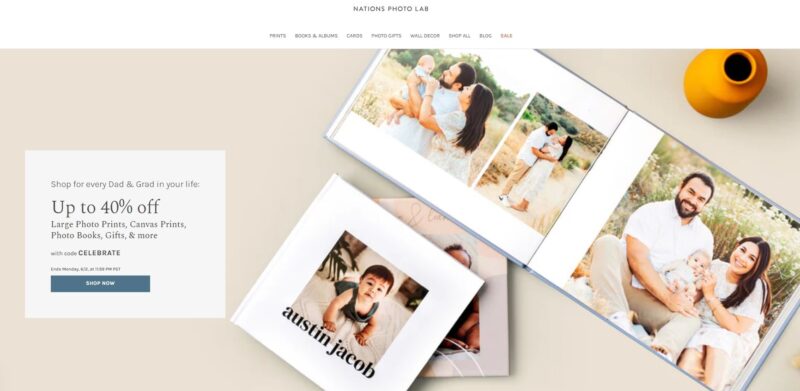 Open photo books on a table showing family portraits, with a promotional banner offering up to 40% off from Nations Photo Lab for Father’s Day and graduation