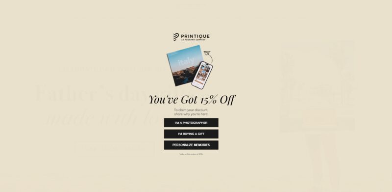 Printique promotional banner offering 15% off for first-time customers with a photo book and mobile gallery preview