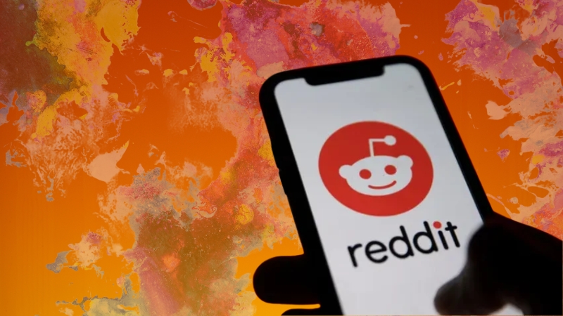 Phone showing Reddit logo on screen with colorful background for Reddit banner